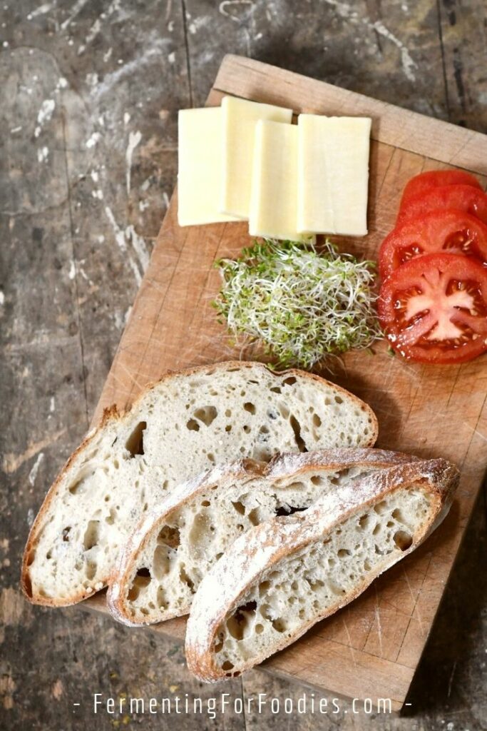 Rustic French sourdough bread with cheese and tomato.