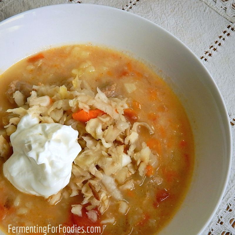 Comforting and cosy sauerkraut soup with sausage, tomatoes and potatoes