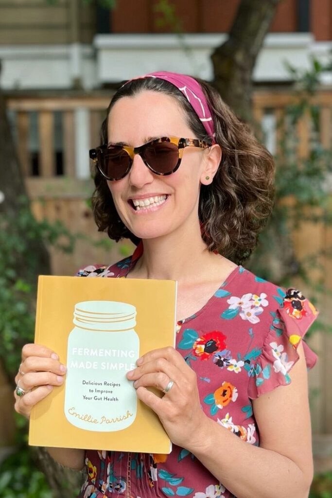 Emillie Parrish holding a copy of Fermenting Made Simple